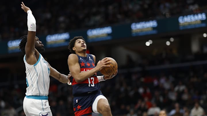 Dec 26, 2024; Washington, District of Columbia, USA; Washington Wizards guard Jordan Poole (13) drives to the basket as Charlotte Hornets center Mark Williams (5) defends in the third quarter at Capital One Arena. Mandatory Credit: Geoff Burke-Imagn Images