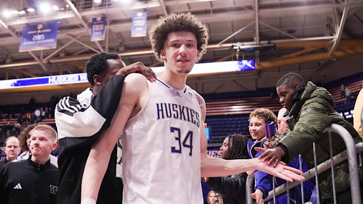 Braxton Meah celebrates a win over UCLA with staff and fans.