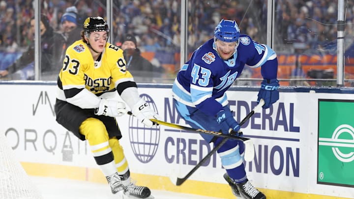 Feb 1, 2026; Tampa Bay, Florida, USA; Tampa Bay Lightning defenseman Darren Raddysh (43) controls the puck as Boston Bruins center Fraser Minten (93) defends during the first period in the 2026 Stadium Series ice hockey game at Raymond James Stadium. Mandatory Credit: Kim Klement Neitzel-Imagn Images