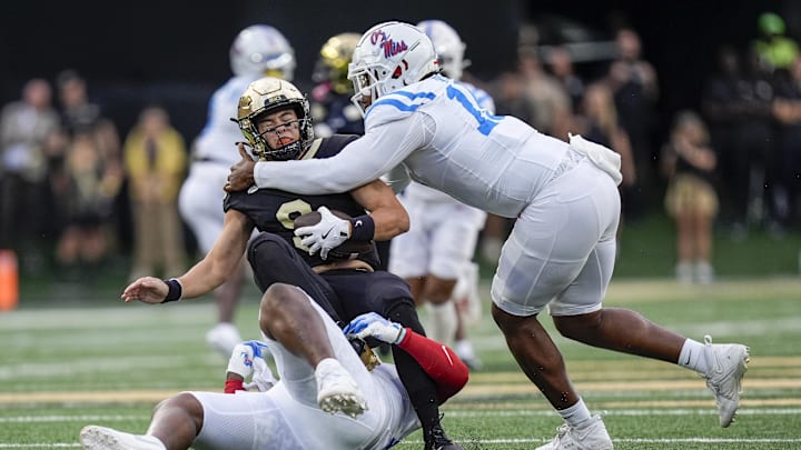 Sep 14, 2024; Winston-Salem, North Carolina, USA; Mississippi Rebels defensive tackle JJ Pegues (89) and defensive end Jared Ivey (15) sack Wake Forest Demon Deacons quarterback Hank Bachmeier (9) during the first half at Allegacy Federal Credit Union Stadium. Mandatory Credit: Jim Dedmon-Imagn Images