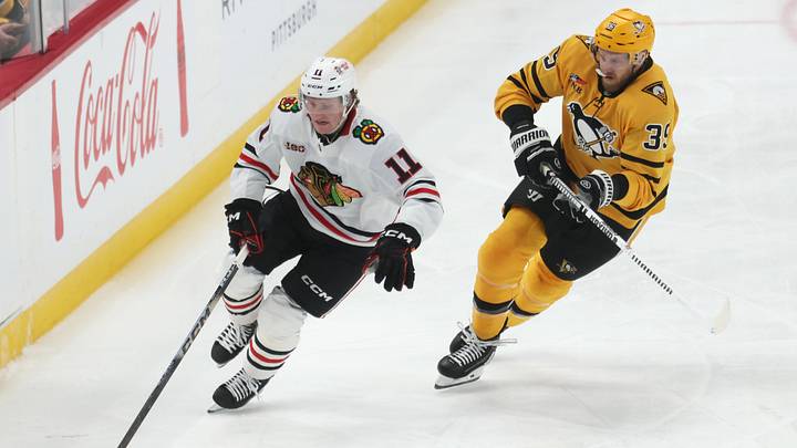 Jan 29, 2026; Pittsburgh, Pennsylvania, USA;  Chicago Blackhawks center Oliver Moore (11) moves the puck as Pittsburgh Penguins right wing Anthony Mantha (39) chases during the third period at PPG Paints Arena. Mandatory Credit: Charles LeClaire-Imagn Images