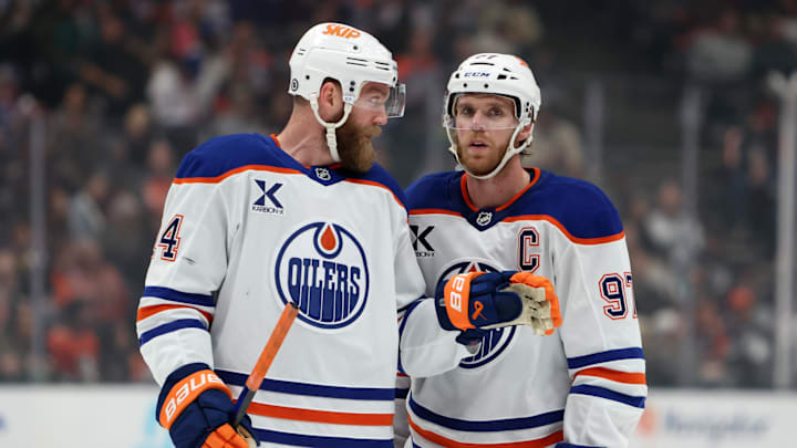 Edmonton Oilers center Connor McDavid (97) talks to defenseman Mattias Ekholm (14)