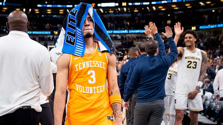 Tennessee guard Bishop Boswell (3) walks off the court as Michigan players celebrate their Final Four berth after an NCAA Tournament Elite 8 game between Tennessee and Michigan at the United Center in Chicago.