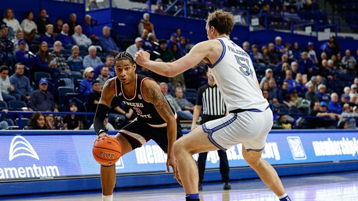Fresno State Bulldogs forward Elijah Price (3) controls the ball as Air Force Falcons center Wesley Celichowski (51). 