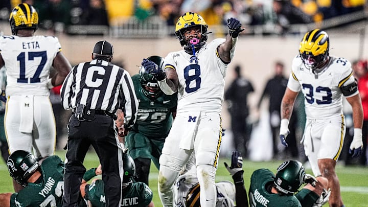Michigan edge Derrick Moore (8) celebrates a sack against Michigan State quarterback Alessio Milivojevic (11) during the second half at Spartan Stadium in East Lansing on Saturday, October 25, 2025.