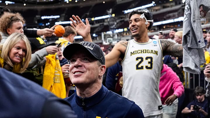 Michigan head coach Dusty May and forward Yaxel Lendeborg exit the court and high-five fans after winning the NCAA Tournament Midwest Regional Championship by 95-62 win over Tennessee at United Center in Chicago on Sunday, March 29, 2026.