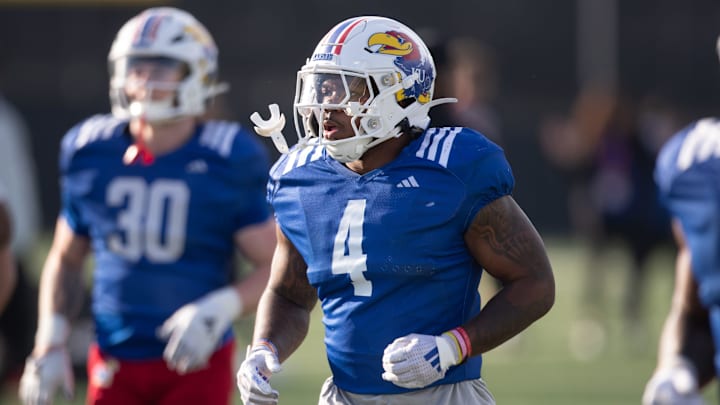 Kansas redshirt senior running back Leshon Williams (4) runs to positions during an outdoor practice on Thursday, March 27, 2025.