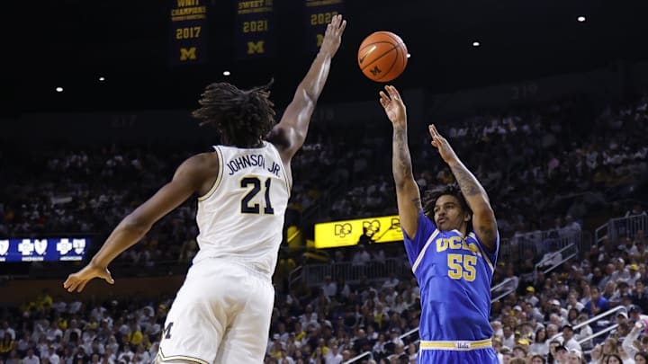 Feb 14, 2026; Ann Arbor, Michigan, USA; UCLA Bruins guard Skyy Clark (55) shoots on Michigan Wolverines forward Morez Johnson Jr. (21) in the second half at Crisler Center. Mandatory Credit: Rick Osentoski-Imagn Images Feb 14, 2026; Ann Arbor, Michigan, USA; UCLA Bruins guard Skyy Clark (55) shoots on Michigan Wolverines forward Morez Johnson Jr. (21) in the second half at Crisler Center. Mandatory Credit: Rick Osentoski-Imagn Images