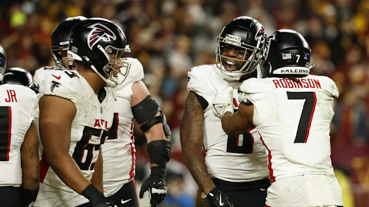 Dec 29, 2024; Landover, Maryland, USA; Atlanta Falcons tight end Kyle Pitts (8) celebrates with teammates after catching a game-tying pass against the Washington Commanders /in the final minutes during the fourth quarter at Northwest Stadium. Mandatory Credit: Geoff Burke-Imagn Images