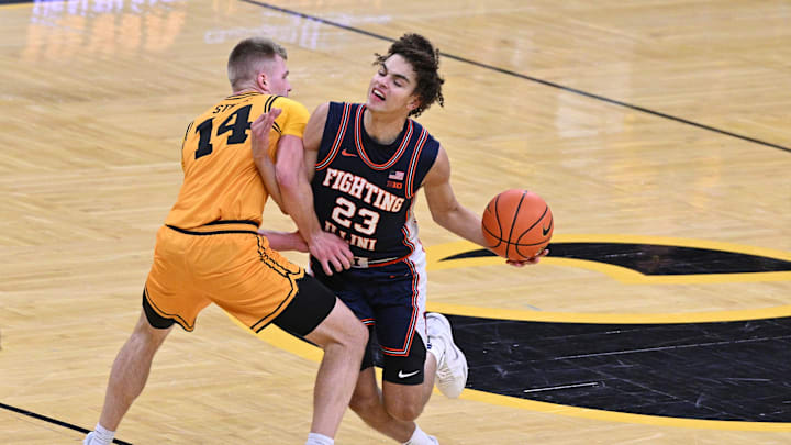 Jan 11, 2026; Iowa City, Iowa, USA; Illinois Fighting Illini guard Keaton Wagler (23) collides with Iowa Hawkeyes guard Bennett Stirtz (14) during the first half at Carver-Hawkeye Arena. Mandatory Credit: Jeffrey Becker-Imagn Images