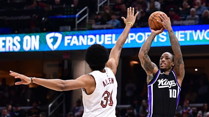Apr 6, 2025; Cleveland, Ohio, USA; Sacramento Kings forward DeMar DeRozan (10) shoots over the defense of  Cleveland Cavaliers center Jarrett Allen (31) during the first half at Rocket Arena. Mandatory Credit: Ken Blaze-Imagn Images