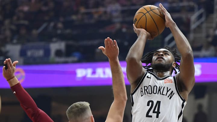 Mar 11, 2025; Cleveland, Ohio, USA; Brooklyn Nets guard Cam Thomas (24) shoots beside Cleveland Cavaliers guard Sam Merrill (5) in the first quarter at Rocket Arena. Mandatory Credit: David Richard-Imagn Images