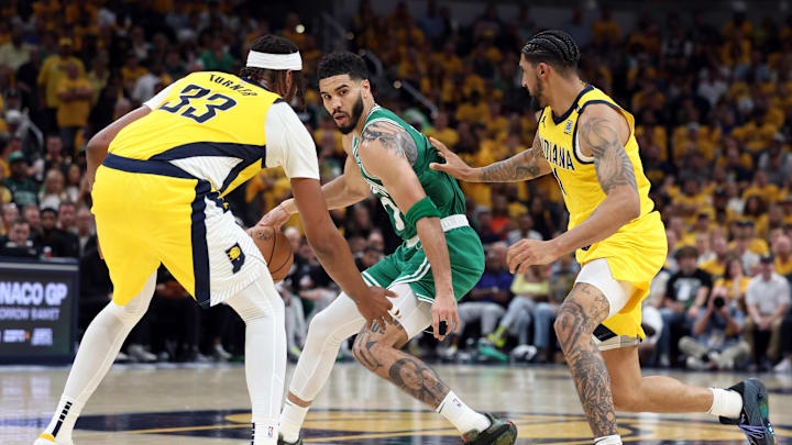 May 25, 2024; Indianapolis, Indiana, USA; Boston Celtics forward Jayson Tatum (middle) controls the ball against Indiana Pacers center Myles Turner (33) and forward Obi Toppin (right) during the fourth quarter of game three of the eastern conference finals in the 2024 NBA playoffs at Gainbridge Fieldhouse. Mandatory Credit: Trevor Ruszkowski-USA TODAY Sports