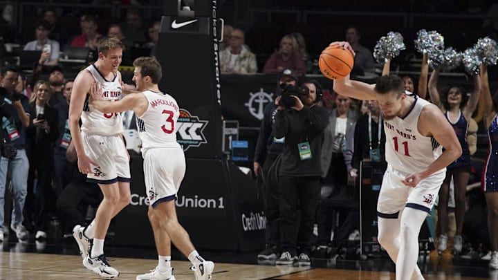 March 12, 2024; Las Vegas, NV, USA; Saint Mary's Gaels guard Luke Barrett (33) and guard Augustas Marciulionis (3) and center Mitchell Saxen (11) celebrate against the Gonzaga Bulldogs after the game in the finals of the WCC Basketball Championship at Orleans Arena. 