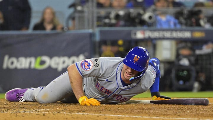 Oct 20, 2024; Los Angeles, California, USA; New York Mets first baseman Pete Alonso (20) reacts after fouling a ball off of his foot in the eighth inning against the Los Angeles Dodgers during game six of the NLCS for the 2024 MLB playoffs at Dodger Stadium. 