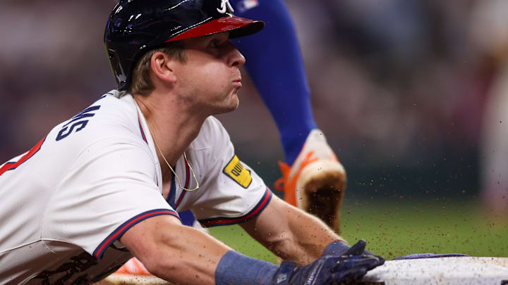 Atlanta Braves shortstop Luke Williams (37) slides safely into third base against the New York Mets in the tenth inning at Truist Park.