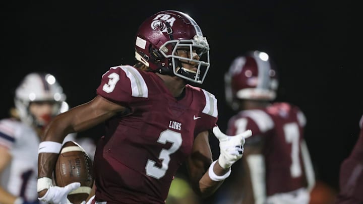 The First Baptist Academy's Jayden Petit runs with the ball against the Estero Wildcats in the season opener at First Baptist Academy in Naples on Friday, Aug. 25, 2023. The Lions defeated the Wildcats 40-7.