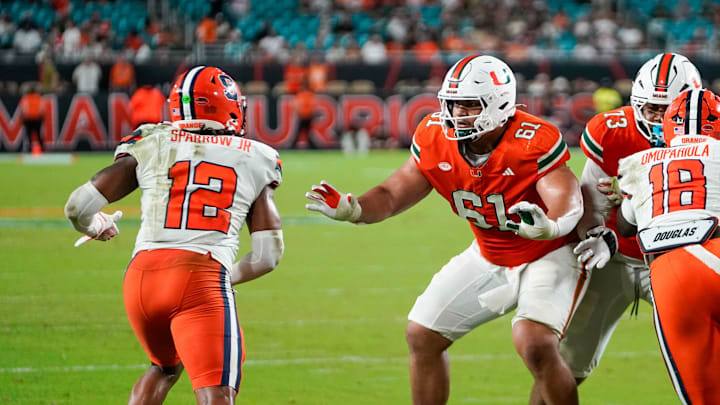 Nov 8, 2025; Miami Gardens, Florida, USA; Miami Hurricanes offensive lineman Francis Mauigoa (61) blocks Syracuse Orange linebacker Anwar Sparrow (12) during the fourth quarter at Hard Rock Stadium. Mandatory Credit: Jeff Romance-Imagn Images
