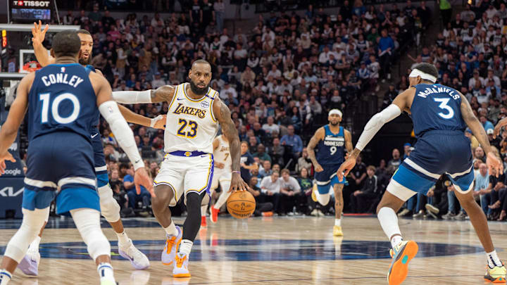 Apr 27, 2025; Minneapolis, Minnesota, USA; Los Angeles Lakers forward LeBron James (23) dribbles with Minnesota Timberwolves forward Jaden McDaniels (3), guard Mike Conley (10) and center Rudy Gobert (27) on defense in the second quarter during game four of first round for the 2025 NBA Playoffs at Target Center. Mandatory Credit: Matt Blewett-Imagn Images Apr 27, 2025; Minneapolis, Minnesota, USA; Los Angeles Lakers forward LeBron James (23) dribbles with Minnesota Timberwolves forward Jaden McDaniels (3), guard Mike Conley (10) and center Rudy Gobert (27) on defense in the second quarter during game four of first round for the 2025 NBA Playoffs at Target Center. Mandatory Credit: Matt Blewett-Imagn Images