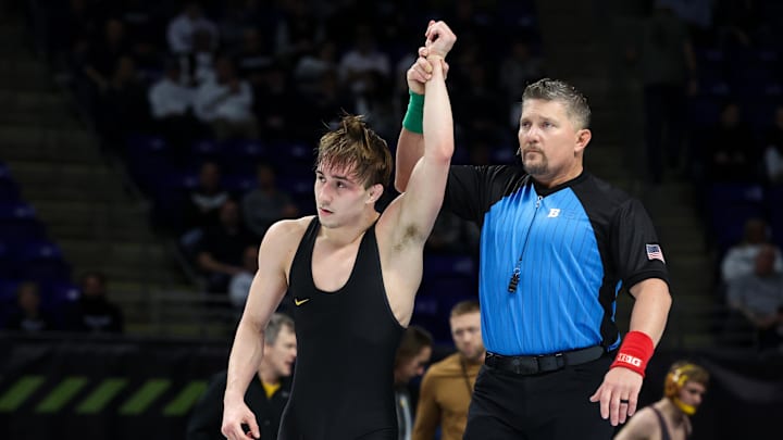 Mar 8, 2026; University Park, PA, USA; Iowa Hawkeyes wrestler Drake Ayala has his arm raised after defeating Illinois Fighting Illini wrestler Lucas Byrd (not pictured) in a 133-pound bout during a consolation semifinal of the Big Ten Wrestling Championships at Bryce Jordan Center. Mandatory Credit: Matthew O'Haren-Imagn Images