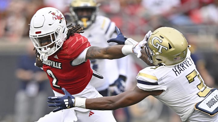 Sep 21, 2024; Louisville, Kentucky, USA;  Louisville Cardinals wide receiver Jadon Thompson (2) runs the ball against Georgia Tech Yellow Jackets defensive back Ahmari Harvey (3) during the second half at L&N Federal Credit Union Stadium. Louisville defeated Georgia Tech 31-19. Mandatory Credit: Jamie Rhodes-Imagn Images
