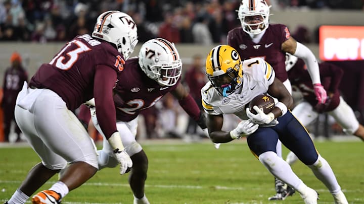 Oct 24, 2025; Blacksburg, Va.; California running back Kendrick Raphael (1) runs after a catch as Virginia Tech defensive lineman Kemari Copeland (13) defends.