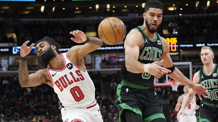 Chicago Bulls guard Coby White (0) and Boston Celtics forward Jayson Tatum (0) go for the ball during the first quarter at United Center. Mandatory Credit: David Banks-Imagn Images