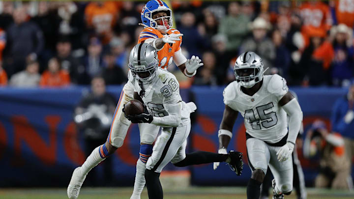 Nov 6, 2025; Denver, Colorado, USA; Las Vegas Raiders cornerback Kyu Blu Kelly (36) makes an interception against the Denver Broncos during the second half at Empower Field at Mile High. Mandatory Credit: Isaiah J. Downing-Imagn Images