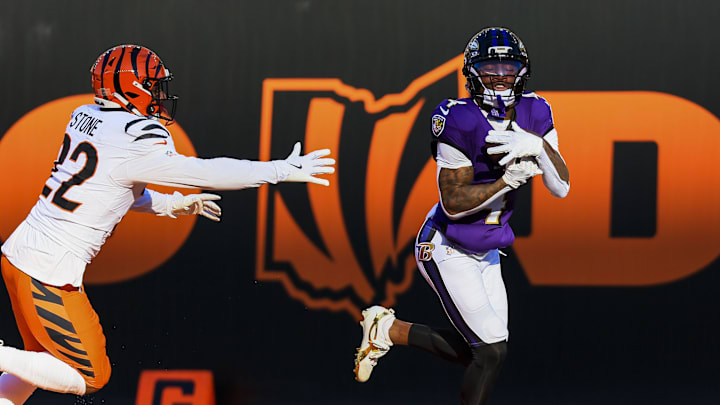 Dec 14, 2025; Cincinnati, Ohio, USA; Baltimore Ravens wide receiver Zay Flowers (4) catches a pass for a touchdown in the first half against Cincinnati Bengals safety Geno Stone (22) at Paycor Stadium. Mandatory Credit: Katie Stratman-Imagn Images
