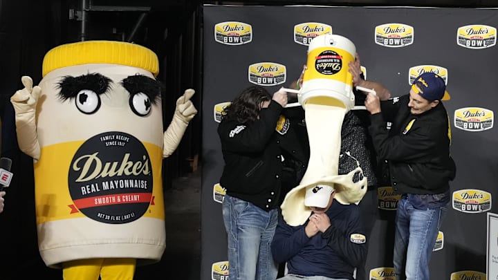 Dec 27, 2023; Charlotte, NC, USA; West Virginia Mountaineers head coach Neal Brown gets covered in mayonnaise after the game at Bank of America Stadium. Mandatory Credit: Bob Donnan-Imagn Images Dec 27, 2023; Charlotte, NC, USA; West Virginia Mountaineers head coach Neal Brown gets covered in mayonnaise after the game at Bank of America Stadium. Mandatory Credit: Bob Donnan-Imagn Images