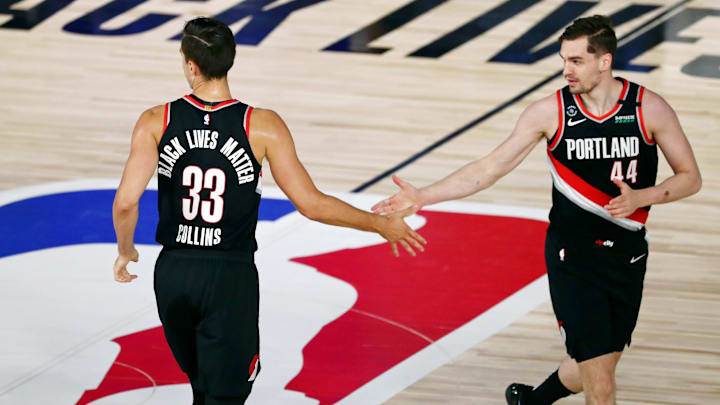 Aug 11, 2020; Lake Buena Vista, Florida, USA; Portland Trail Blazers forward Zach Collins (33) high fives forward Mario Hezonja (44) after making a three point basket against the Dallas Mavericks during the first half of a NBA game at The Field House. Mandatory Credit: Kim Klement-Imagn Images