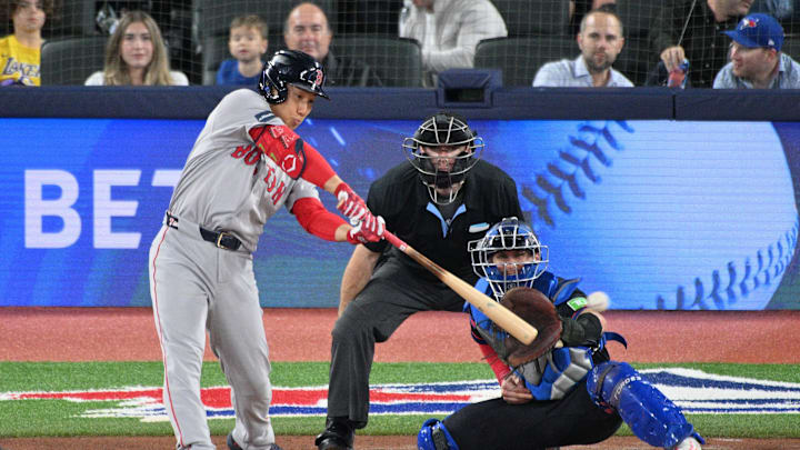 Boston Red Sox designated hitter Masataka Yoshida (7) hits a double against the Toronto Blue Jays in the fourth inning at Rogers Centre on Sept 25. Boston Red Sox designated hitter Masataka Yoshida (7) hits a double against the Toronto Blue Jays in the fourth inning at Rogers Centre on Sept 25.