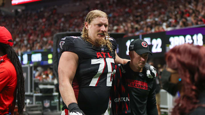 Falcons offensive tackle and former Husky Kaleb McGary (76) leaves the field with an injury in 2024. Falcons offensive tackle and former Husky Kaleb McGary (76) leaves the field with an injury in 2024.