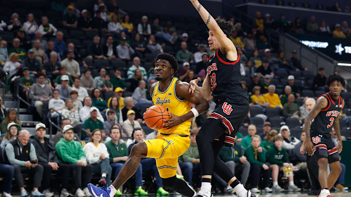 Mar 7, 2026; Waco, Texas, USA;  Baylor Bears guard Tounde Yessoufou (24) drives to the basket ahead of Utah Utes forward James Okonkwo (32) during the first half at Paul and Alejandra Foster Pavilion. Mandatory Credit: Chris Jones-Imagn Images
