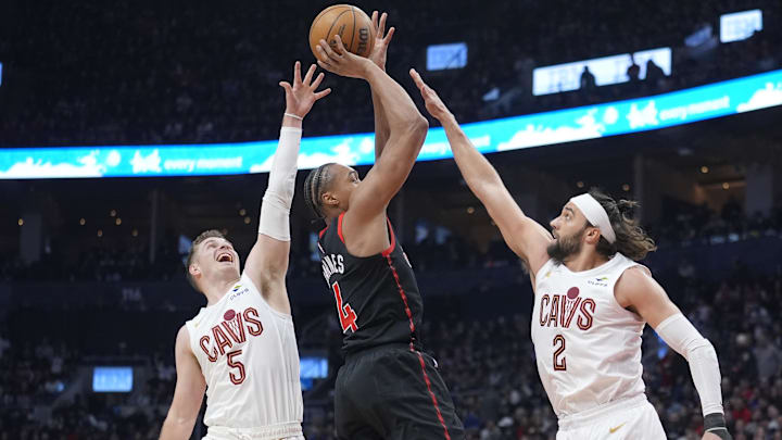 Apr 23, 2026; Toronto, Ontario, CAN; Cleveland Cavaliers guard Sam Merrill (5) and guard Max Strus (2) defend against Toronto Raptors guard Scottie Barnes (4) during the first half of game three of the first round of the 2026 NBA Playoffs at Scotiabank Arena. Mandatory Credit: John E. Sokolowski-Imagn Images