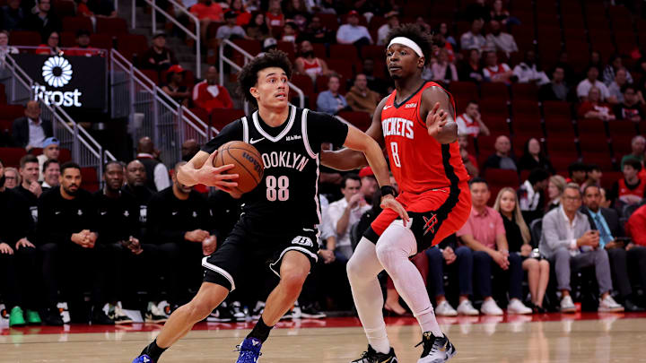 Oct 27, 2025; Houston, Texas, USA; Brooklyn Nets guard Nolan Traore (88) drives to the basket against Houston Rockets forward Jae'Sean Tate (8) during the fourth quarter at Toyota Center. Mandatory Credit: Erik Williams-Imagn Images

