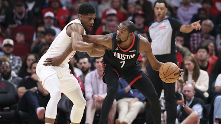 Dec 27, 2025; Houston, Texas, USA;  Cleveland Cavaliers forward De'Andre Hunter (12) defends against Houston Rockets forward Kevin Durant (7) during the first quarter at Toyota Center. Mandatory Credit: Troy Taormina-Imagn Images