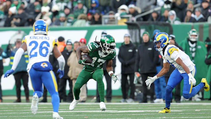 Dec 22, 2024; East Rutherford, New Jersey, USA; New York Jets wide receiver Davante Adams (17) runs with the ball against Los Angeles Rams safety Kamren Kinchens (26) and cornerback Ahkello Witherspoon (4) during the fourth quarter at MetLife Stadium. Mandatory Credit: Brad Penner-Imagn Images
