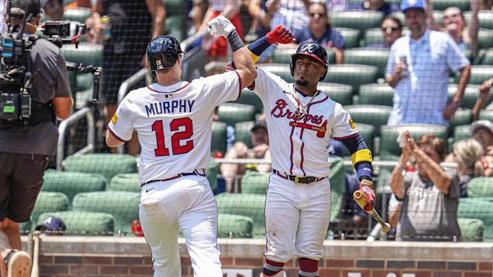 Jul 6, 2025; Cumberland, Georgia, USA; Atlanta Braves catcher Sean Murphy (12) reacts with second baseman Ozzie Albies (1)  after hitting a home run against the Baltimore Orioles during the ninth inning at Truist Park. Mandatory Credit: Dale Zanine-Imagn Images