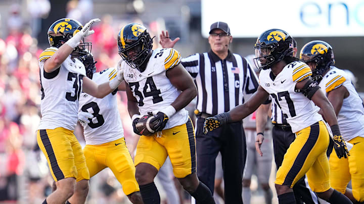 Oct 5, 2024; Columbus, OH, USA; Iowa Hawkeyes linebacker Jay Higgins (34) celebrates a fumble recovery after forcing Ohio State Buckeyes wide receiver Jeremiah Smith to lose the ball during the first half of the NCAA football game at Ohio Stadium.