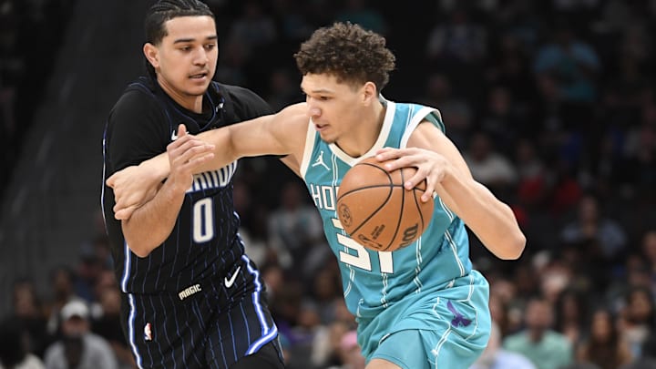 Mar 25, 2025; Charlotte, North Carolina, USA;  Charlotte Hornets forward Tidjane Salaun (31) drives past Orlando Magic guard Anthony Black (0) during the first half at the Spectrum Center. Mandatory Credit: Sam Sharpe-Imagn Images