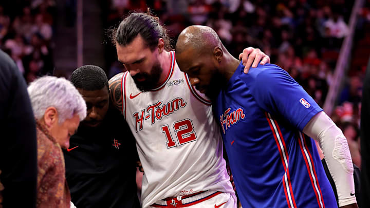 Jan 18, 2026; Houston, Texas, USA; Houston Rockets center Steven Adams (12) is helped off the court after an injury against the New Orleans Pelicans during the fourth quarter at Toyota Center. Mandatory Credit: Erik Williams-Imagn Images