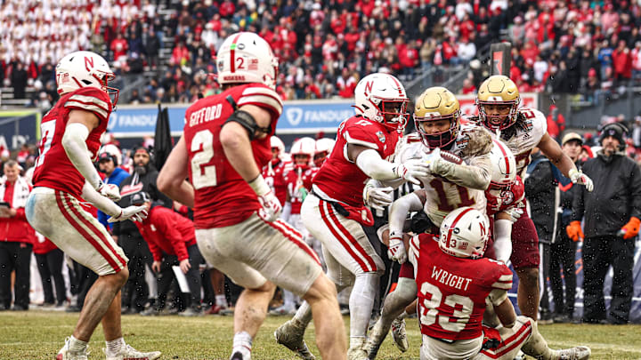 Dec 28, 2024; Bronx, NY, USA; Boston College Eagles wide receiver Lewis Bond (11) is tackled by Nebraska Cornhuskers linebacker Javin Wright (33) during the second half at Yankee Stadium. Mandatory Credit: Vincent Carchietta-Imagn Images