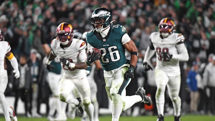 Nov 14, 2024; Philadelphia, Pennsylvania, USA; Philadelphia Eagles running back Saquon Barkley (26) runs past Washington Commanders defenders on way to a 39-yard touchdown during the fourth quarter against the Washington Commanders at Lincoln Financial Field. Mandatory Credit: Eric Hartline-Imagn Images