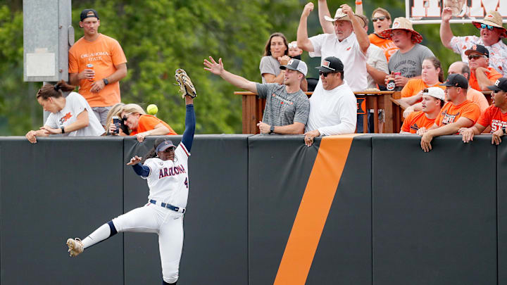 Arizona's Dakota Kennedy (4) can not catch the home run ball of Oklahoma State's Tallen Edwards in the first inning of Game 2 of the NCAA softball tournament Stillwater Super Regional between the Oklahoma State Cowgirls and the Arizona Wildcats in Stillwater, Okla., Saturday, May, 25, 2024.