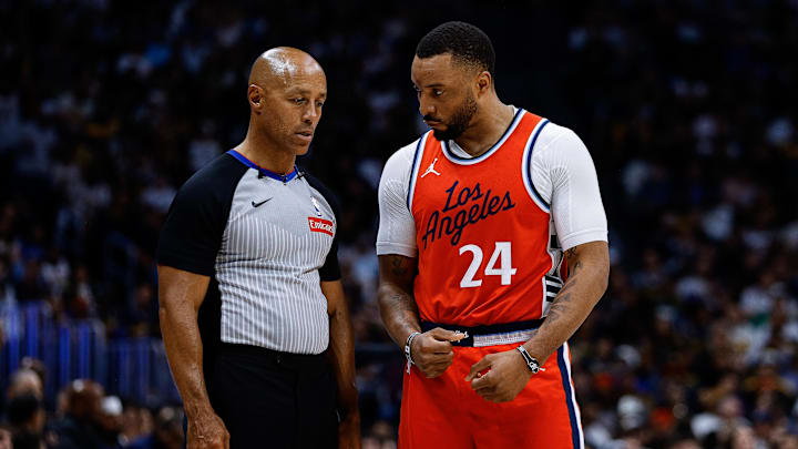 Apr 21, 2025; Denver, Colorado, USA; Los Angeles Clippers guard Norman Powell (24) talks with referee Marc Davis (8) in the third quarter against the Denver Nuggets during game two of first round for the 2025 NBA Playoffs at Ball Arena. Mandatory Credit: Isaiah J. Downing-Imagn Images