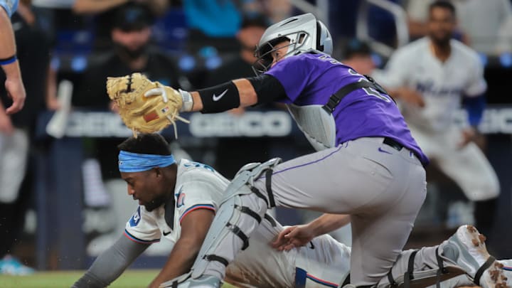 Jun 4, 2025; Miami, Florida, USA; Miami Marlins right fielder Jesus Sanchez (7) is tagged out at home plate by Colorado Rockies catcher Jacob Stallings (25) during the seventh inning at loanDepot Park. Jun 4, 2025; Miami, Florida, USA; Miami Marlins right fielder Jesus Sanchez (7) is tagged out at home plate by Colorado Rockies catcher Jacob Stallings (25) during the seventh inning at loanDepot Park.