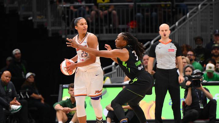 Aug 17, 2025; Seattle, Washington, USA; Phoenix Mercury forward Alyssa Thomas (25) looks to pass the ball while guarded by Seattle Storm forward Nneka Ogwumike (3) during the second half at Climate Pledge Arena. Mandatory Credit: Steven Bisig-Imagn Images