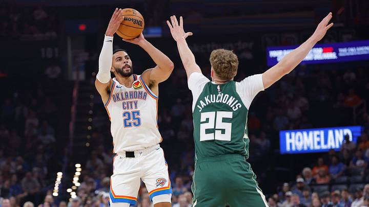 Oct 7, 2026; Oklahoma City, Oklahoma, USA; Oklahoma City Thunder guard Ajay Mitchell (25) shoots over Milwaukee Bucks guard Kasparas Jakucionis (25) during the first half of a preseason game at Paycom Center. Mandatory Credit: Alonzo Adams-Imagn Images Oct 7, 2026; Oklahoma City, Oklahoma, USA; Oklahoma City Thunder guard Ajay Mitchell (25) shoots over Milwaukee Bucks guard Kasparas Jakucionis (25) during the first half of a preseason game at Paycom Center. Mandatory Credit: Alonzo Adams-Imagn Images