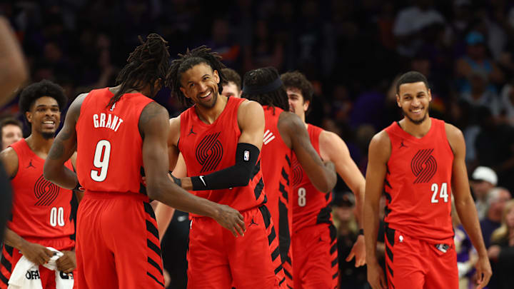 Portland Trail Blazers guard Matisse Thybulle celebrates with Jerami Grant.